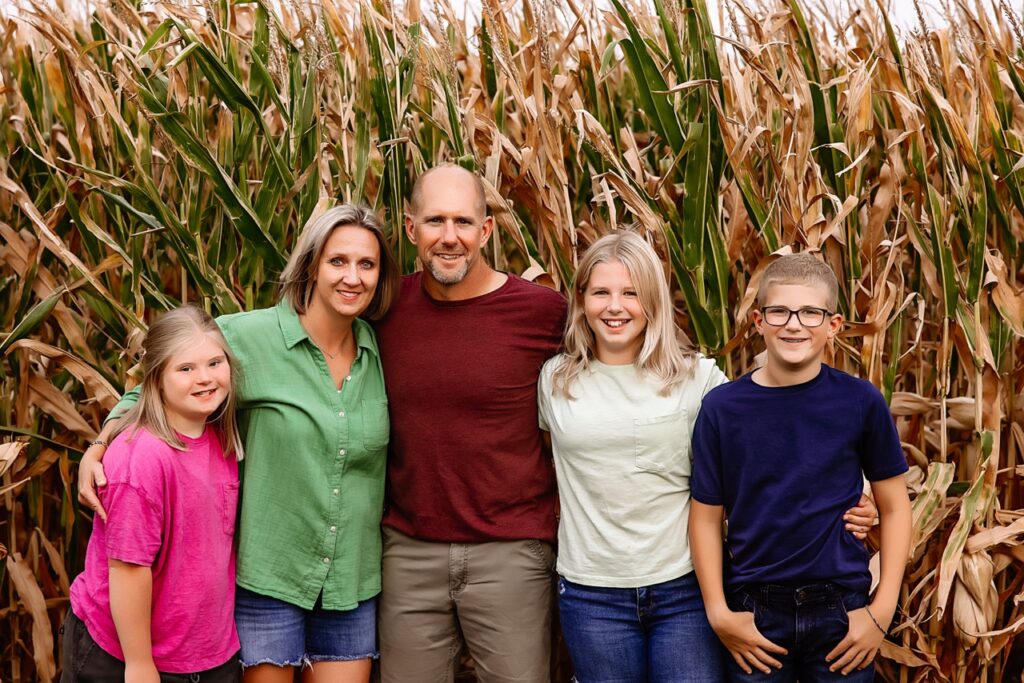 Biegler family standing in front of corn